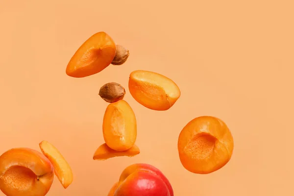Flying Halves Fresh Apricot Pieces Orange Background — Stock Photo, Image