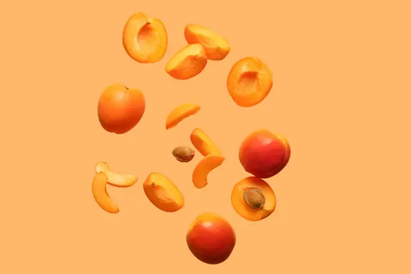 Flying Fresh Apricots Pieces Orange Background — Stock Photo, Image