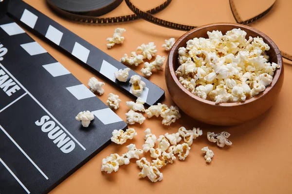 Schüssel Mit Leckerem Popcorn Klappbrett Und Filmrolle Auf Braunem Hintergrund — Stockfoto