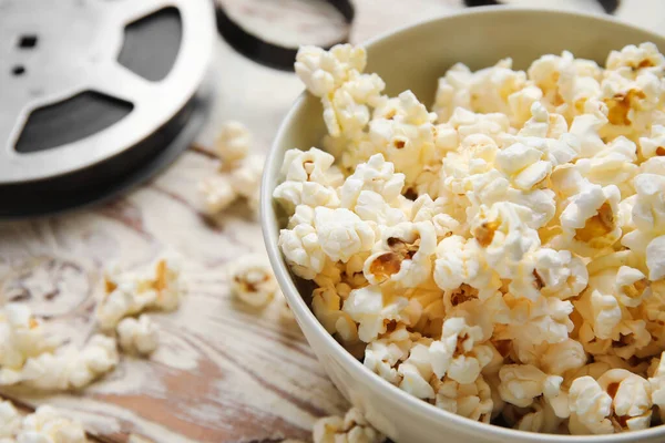 Bowl Tasty Popcorn Film Reel White Wooden Background Closeup — Stock Photo, Image