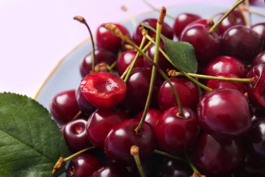 Tatlı kiraz ve yapraklı tabak, yakın plan.