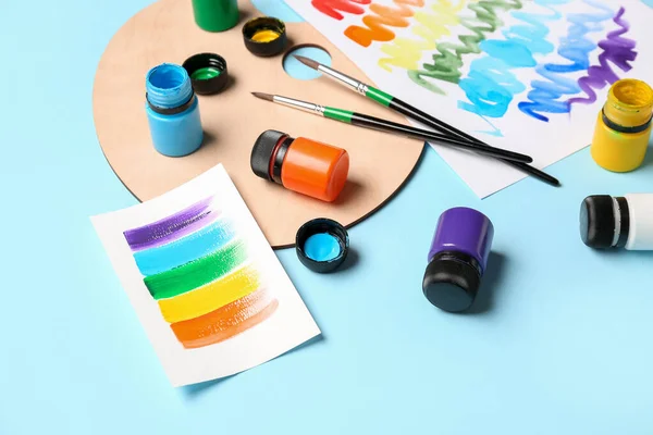 Skład Różnymi Farbami Pędzlami Tęczową Paletą Kolorów Niebieskim Tle — Zdjęcie stockowe