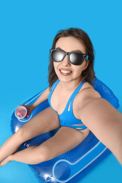 Young Woman Sunglasses Swim Ring Taking Selfie Blue Background — Stock Photo, Image