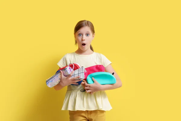 Shocked Little Girl Pencil Cases Yellow Background — Stock Photo, Image