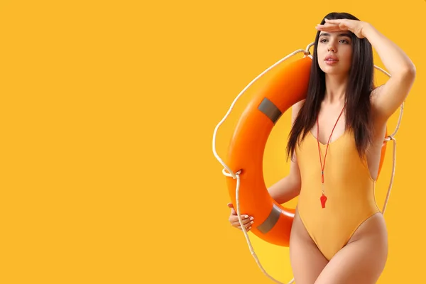Female Lifeguard Ring Buoy Yellow Background — Stock Photo, Image