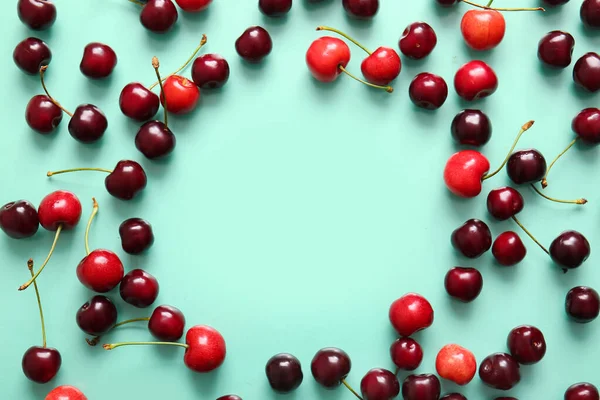 stock image Frame made of sweet cherries on turquoise background