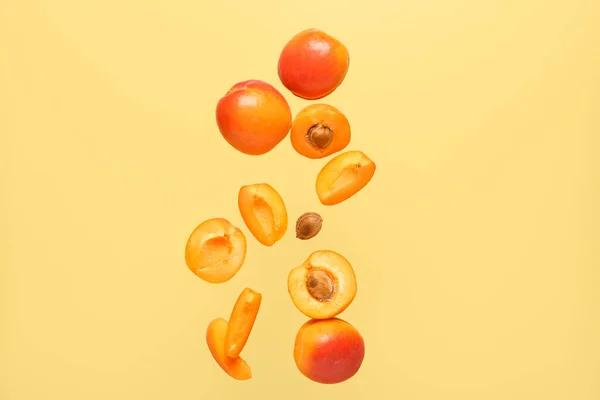 Flying Fresh Apricots Pieces Yellow Background — Stock Photo, Image