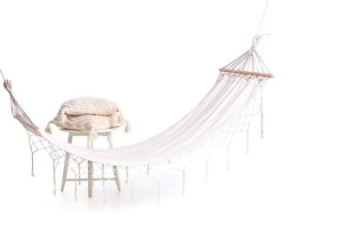 Beyaz arka planda izole edilmiş minderleri olan rahat hamak ve tabure