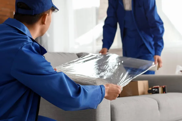 Male Movers Wrapping Sofa Stretch Film Room Closeup — Stock Photo, Image