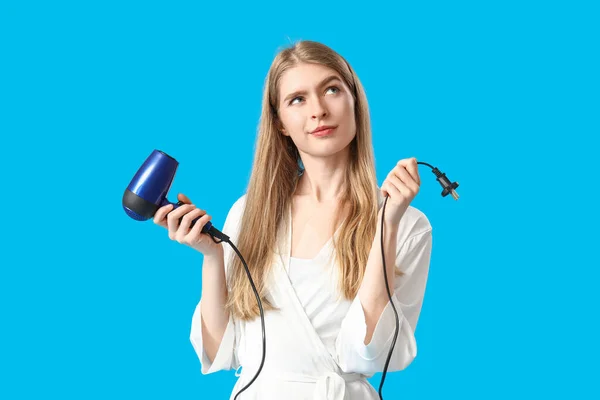 Thoughtful Young Blonde Woman Hair Dryer Blue Background — Stock Photo, Image