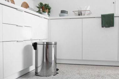 Mutfağın içindeki metal çöp tenekesi.