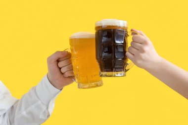 Sarı arka planda bira içen Alman erkek ve kadın. Ekim Festivali Kutlaması