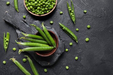 Siyah arka planda taze bezelyeler.