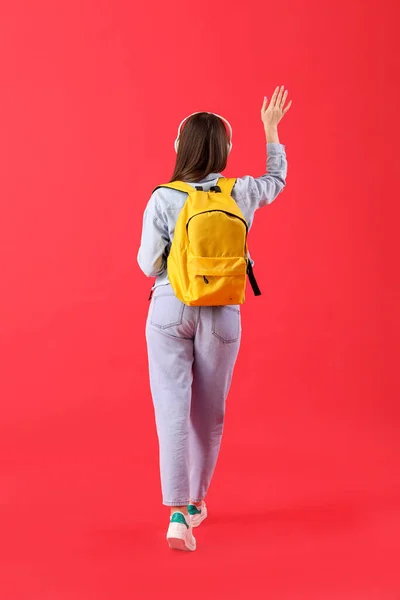 Female Student Headphones Backpack Red Background Back View — Stock Photo, Image