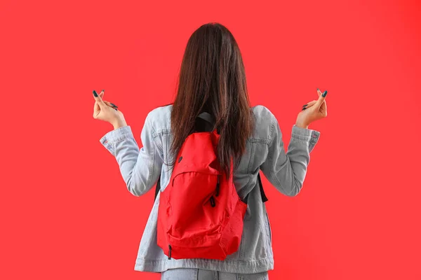Female Student Backpack Making Heart Shape Red Background Back View — Stock Photo, Image