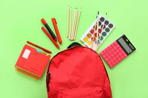 Red School Backpack Calculator Color Pencils Watercolors Green Background — Stock Photo, Image