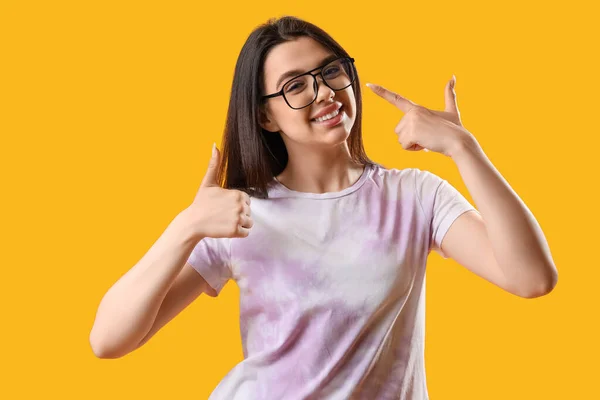 Pretty Young Woman Wearing Glasses Showing Thumb Yellow Background — Stock Photo, Image