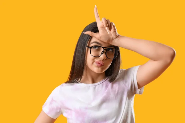 Pretty Young Woman Wearing Glasses Showing Loser Gesture Yellow Background — Stock Photo, Image