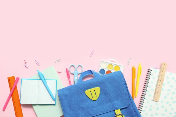 stock image School backpack with different stationery on pink background