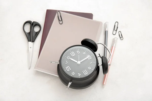 白い背景に異なる文房具と目覚まし時計 — ストック写真