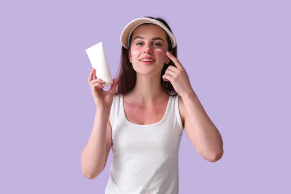 Allergic Young Woman Applying Cream Her Sunburned Face Lilac Background — Stock Photo, Image