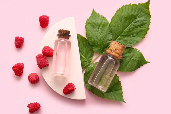 Decorative Podium Bottles Cosmetic Raspberry Oil Pink Background — Stock Photo, Image