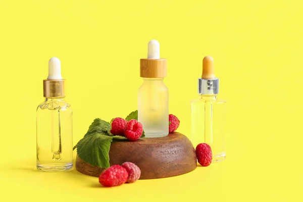 Bottles Cosmetic Raspberry Oil Yellow Background — Stock Photo, Image