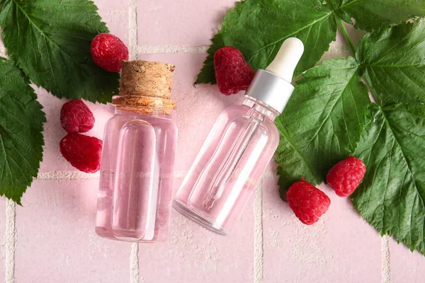 Bottles Cosmetic Raspberry Oil Pink Tile Background — Stock Photo, Image