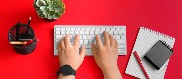 Hands Modern Computer Keyboard Stationery Red Background — Stock Photo, Image