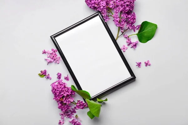 stock image Composition with beautiful lilac flowers and blank frame on light background