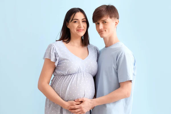 Mladý Těhotný Pár Modrém Pozadí — Stock fotografie