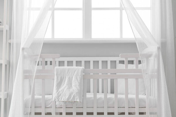 Interior of stylish children's bedroom with crib