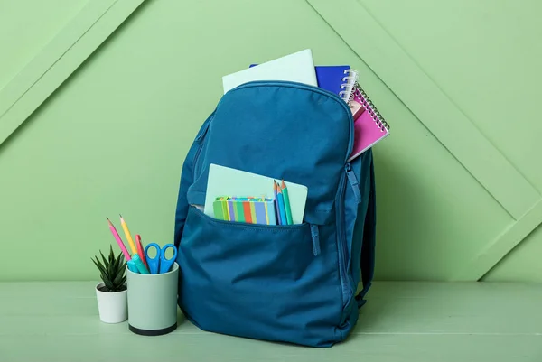 Blue School Backpack Notebooks Pencils Houseplant Wooden Table Green Wall — Stock Photo, Image