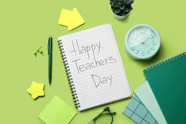 Notebooks with text HAPPY TEACHERS DAY, alarm clock and stationery on green background