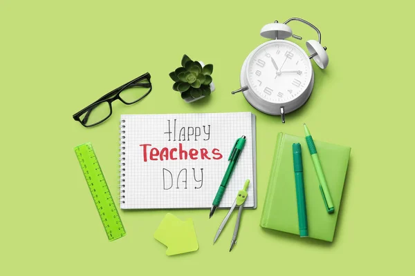 Notebooks with text HAPPY TEACHERS DAY, eyeglasses and stationery on green background