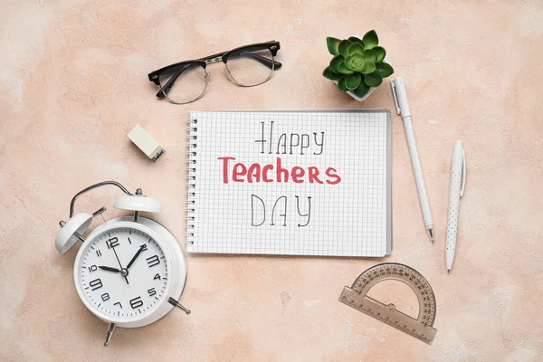 Notebook with text HAPPY TEACHERS DAY, eyeglasses and different stationery on grunge pink background
