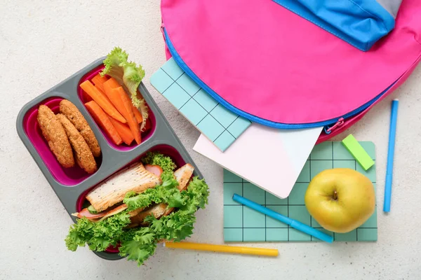 Backpack Stationery Lunch Box Tasty Food Grunge Light Background — Stock Photo, Image