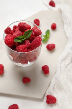 Taze ahududu ve nane arkaplanlı cam, yakın plan.