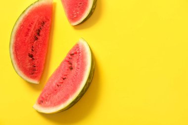 Sarı arka planda taze karpuz parçaları.