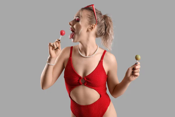 Young Woman Swimsuit Eating Lollipops Grey Background — Stock Photo, Image