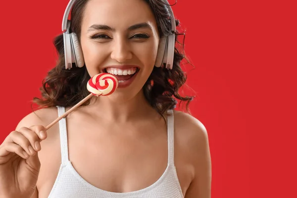 Young Woman Headphones Eating Lollipop Red Background Closeup — Stock Photo, Image
