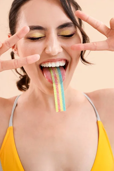 Young Woman Swimsuit Eating Jelly Candy Beige Background Closeup — Stock Photo, Image