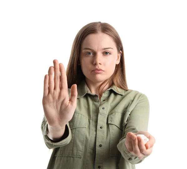 stock image Young female junkie with drugs showing STOP gesture on white background