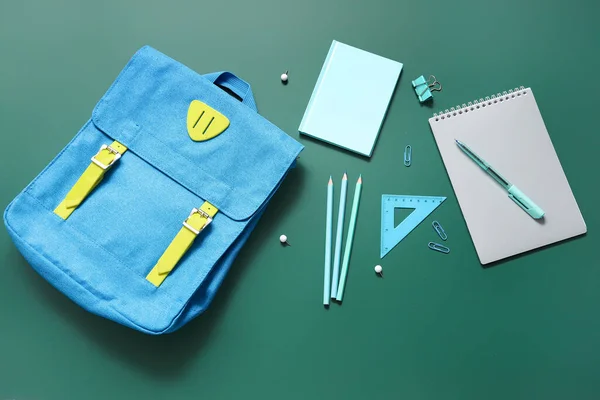 蓝色学校背包 带有绿色背景的笔记本 纸夹和铅笔 — 图库照片