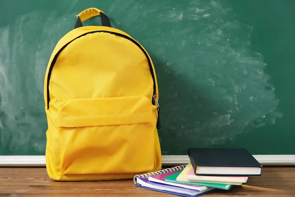 Yellow Σχολική Τσάντα Πλάτης Σημειωματάρια Ξύλινο Τραπέζι Κοντά Πράσινο Chalkboard — Φωτογραφία Αρχείου