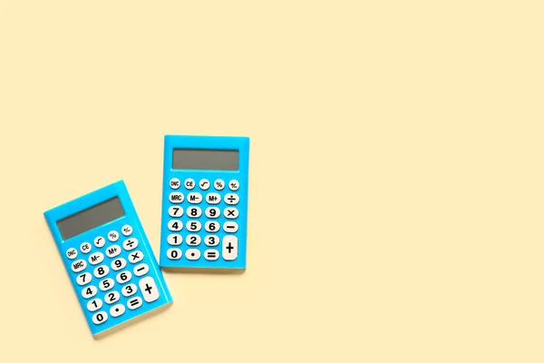 Modern Calculators Pale Yellow Background — Stock Photo, Image