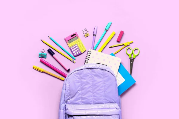 stock image Backpack with calculators and different stationery on lilac background