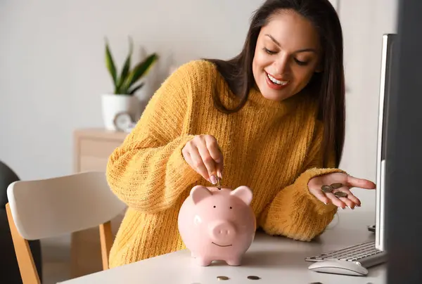 Young Woman Putting Coin Piggy Bank Home — Stock Photo, Image