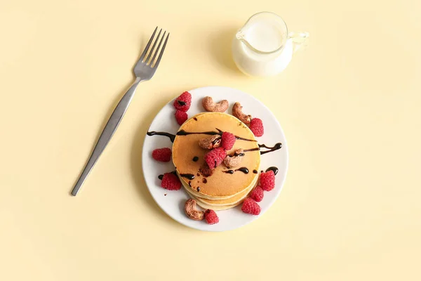 Plate Tasty Pancakes Raspberries Nuts Yellow Background — Stock Photo, Image