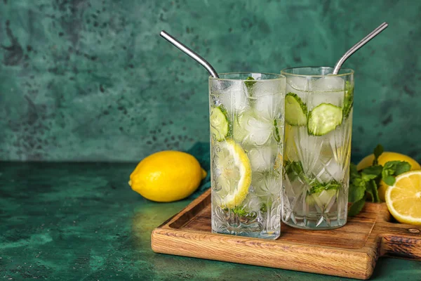 stock image Glasses of mojito with cucumber on grunge green table